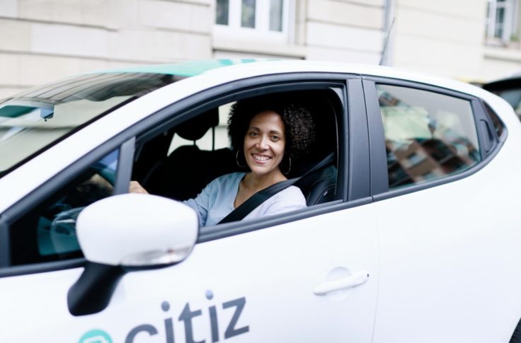 smiling woman driving a citiz car