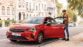 man rents and opens a red poppy carsharing car